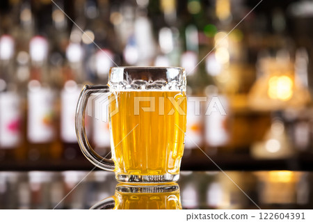 Closeup image of mug with golden cold light beer at bar background. 122604391