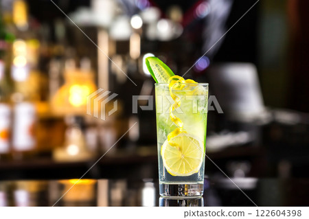 Glass of gin tonic cocktail decorated with cucumber at bat counter background. 122604398