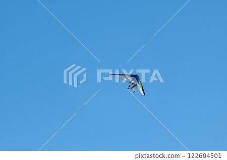White Hang Glider against blue sky 122604501