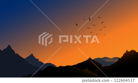 Mountain silhouette at sunset with flying birds in the sky 122604517