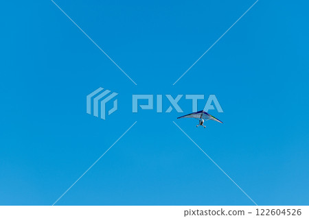 White Hang Glider against blue sky 122604526