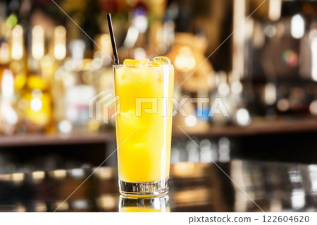 Glass of fresh pineapple juice at bar counter background. Glass of fresh pineapple juice at bar counter background. 122604620