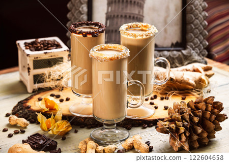 Closeup group of hot coffee glasses decorated with beans, nuts and fruits at wooden table background. Closeup group of hot coffee glasses decorated with beans, nuts and fruits at wooden table background. 122604658