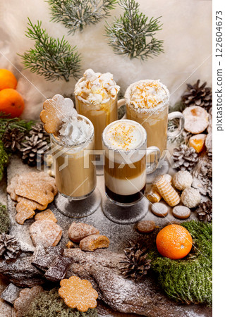 Vertical image of layered christmas coffee glasses set at decorated with moss, tangerines, cookies, sugar powder as a snow natural wooden board bakground. Vertical image of layered christmas coffee glasses set at decorated with moss, tangerines, cookies, sugar powder as a snow natural wooden board bakground. 122604673