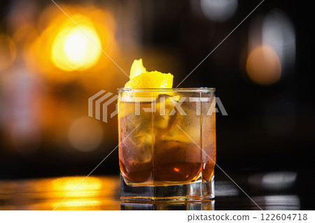 Closeup image of glass of cuba libre cocktail at bright blurred background. 122604718
