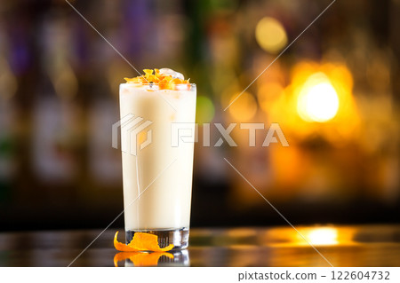 Closeup glass of milk shake cocktail at bright bar counter background. 122604732
