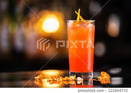 Closeup glass of cold fresh rosemary cocktail decorated with orange at bright bar counter background. Closeup glass of cold fresh rosemary cocktail decorated with orange at bright bar counter background. 122604735