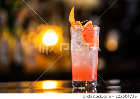 Closeup glass of greyhound cocktail decorated with grapefruit at bright bar counter background. 122604739