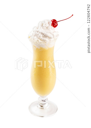 Closeup glass of yellow pina colada cocktail decorated with cocktail cherry and whipped cream isolated at white background. Closeup glass of yellow pina colada cocktail decorated with cocktail cherry and whipped cream isolated at white background. 122604742