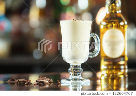 Glass of pina colada cocktail at colorful bar counter background. 122604767