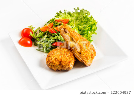 Fried golden chicken with cheese and vegetables on plate isolated at white background. 122604927