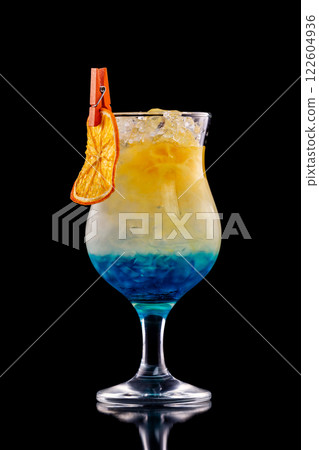 Closeup glass of blue curacao cocktail decorated with orange isolated at black background. 122604936
