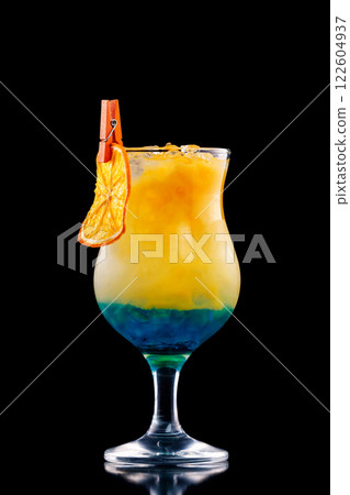 Closeup glass of blue curacao cocktail decorated with orange isolated at black background. Closeup glass of blue curacao cocktail decorated with orange isolated at black background. 122604937