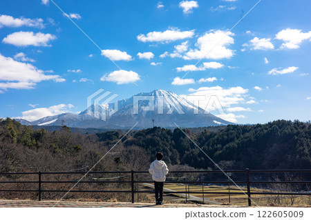Boy looking at snowy mountains Boy looking at snowy mountains 122605009