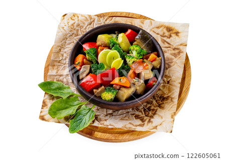 Pan of grilled vegetables served at a wooden tray isolated at white background. Concept of healthy lifestyle. 122605061