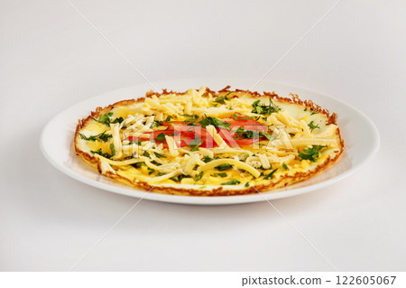 Fried eggs with cheese, tomato and parsley on a plate isolated at white background. 122605067
