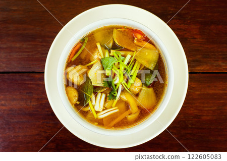 Bowl of fresh spicy hot thai soup Tom Yum at wooden table background. Bowl of fresh spicy hot thai soup Tom Yum at wooden table background. 122605083