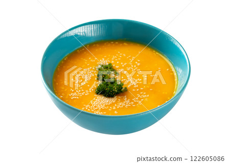 Closeup bowl of pumpkin soup decorated with parsley and sesame isolated at white background. Concept of healthy lifestyle. 122605086