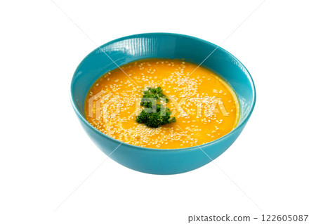 Closeup bowl of pumpkin soup decorated with parsley and sesame isolated at white background. Concept of healthy lifestyle. 122605087