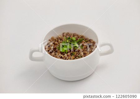 Bowl of fresh diet buckwheat porridge isolated at white background. 122605090