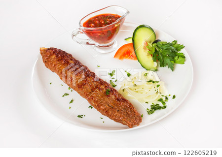 National meal beef shish kebab with sauce isolated at white background. National meal beef shish kebab with sauce isolated at white background. 122605219