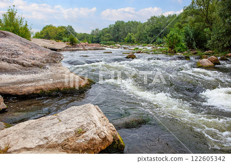Flowing waters create a symphony of nature amidst serene landscapes and rocky formations Flowing waters create a symphony of nature amidst serene landscapes and rocky formations 122605342