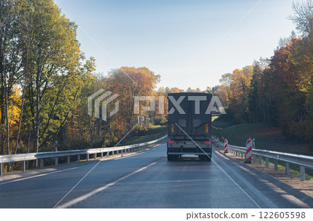 Rear view of a truck on a autumn road 122605598