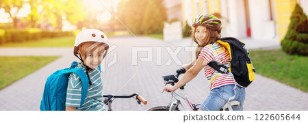 Boy and girl on the bicycles riding together. Boy and girl on the bicycles riding together. 122605644