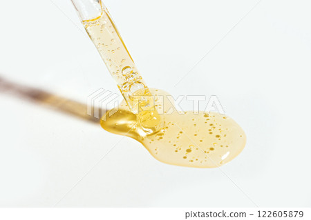 Dropper with  swatch of cosmetic retinol serum 122605879