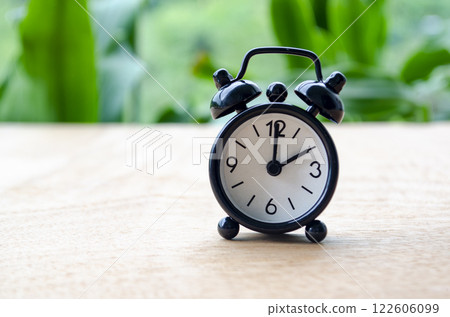 Table alarm clock pointing at 2pm or 2am with customizable space for text. Time management concept and copy space Table alarm clock pointing at 2pm or 2am with customizable space for text. Time management concept and copy space 122606099