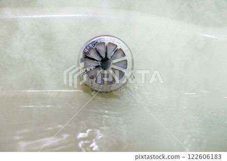 Bathtub filling with hot water water heater 122606183