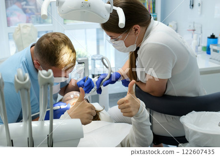 Young dentist at work in the office 122607435