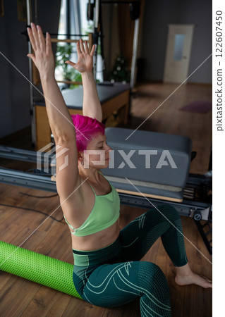 Positive sporty woman doing fascia exercise on the floor - Caucasian female using foam massage roller - tool for back tension and muscle pain release - physical therapy and training stretch concept Positive sporty woman doing fascia exercise on the floor - Caucasian female using foam massage roller - tool for back tension and muscle pain release - physical therapy and training stretch concept 122607450