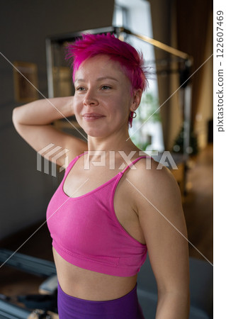 Portrait of woman pilates trainer standing near the Ladder Barrel. Pilates equipment. Pilates studio machine for fitness workouts in gym. Fit, healthy and strong authentical body. Fitness concept Portrait of woman pilates trainer standing near the Ladder Barrel. Pilates equipment. Pilates studio machine for fitness workouts in gym. Fit, healthy and strong authentical body. Fitness concept 122607469