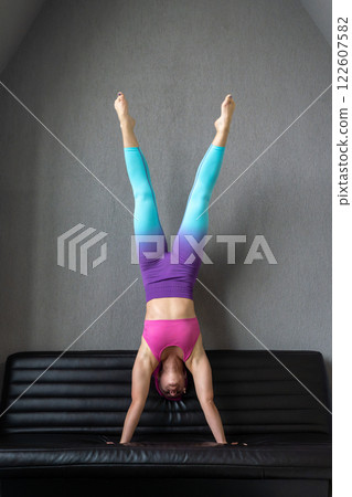 Dynamic Yoga Pose on Couch Embracing Flexibility in Action with Poise and Control 122607582