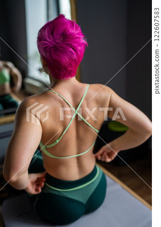 Pilates fitness trainer beautiful back relief. Pilates studio. Young sporty attractive woman wearing sportswear in yoga studio. Fit, healthy and strong authentical body. Fitness concept Pilates fitness trainer beautiful back relief. Pilates studio. Young sporty attractive woman wearing sportswear in yoga studio. Fit, healthy and strong authentical body. Fitness concept 122607583