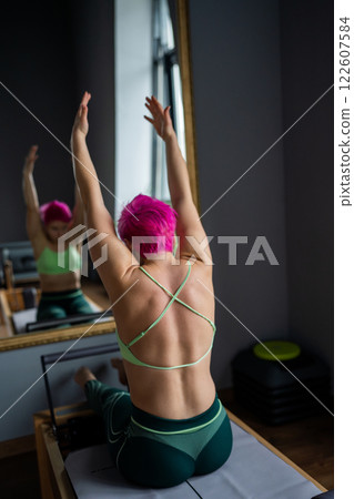 Join us for an invigorating and vibrant workout session that focuses on the Pilates Reformer Join us for an invigorating and vibrant workout session that focuses on the Pilates Reformer 122607584