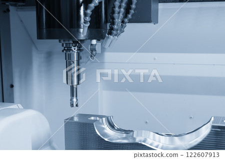 The CNC milling machine rough cutting the injection mold parts by indexable tools in the light blue scene. The CNC milling machine rough cutting the injection mold parts by indexable tools in the light blue scene. 122607913