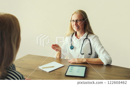 Woman doctor therapist talking to girl patient prescribes medications in clinic office 122608462