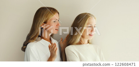 Upset offended caucasian middle aged mother or sister and adult daughter together 122608471