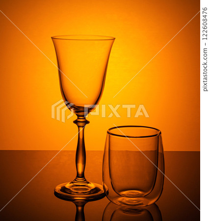 a wine glass and a mulled wine glass on an orange background a wine glass and a mulled wine glass on an orange background 122608476