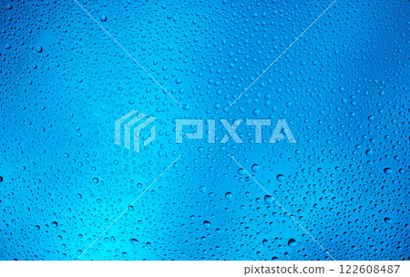 Glowing blue background with contrasting water drops 122608487