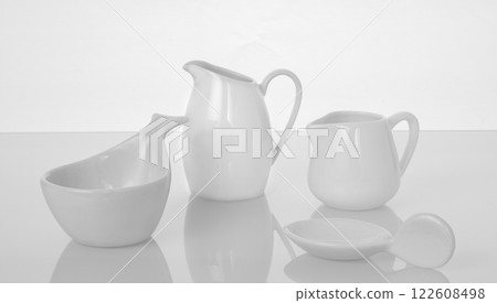 group of white dishes with reflection in glass photo in pencil drawing style 122608498