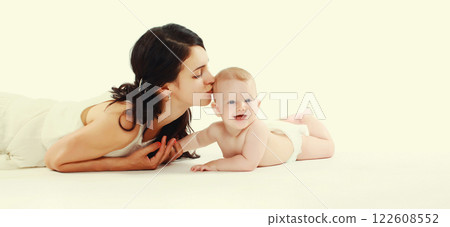 happy young mother playing with baby lying on the floor happy young mother playing with baby lying on the floor 122608552