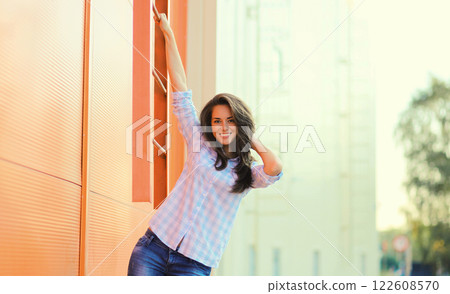 Portrait beautiful happy smiling brunette young woman posing in the city Portrait beautiful happy smiling brunette young woman posing in the city 122608570