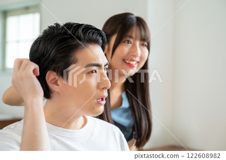 A Japanese man consulting a female staff member about his hair 122608982