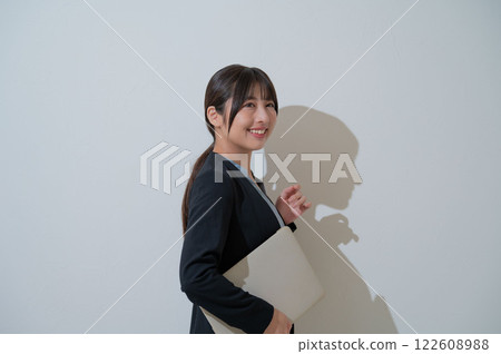 拿著筆記型電腦的微笑的日本女商人 122608988