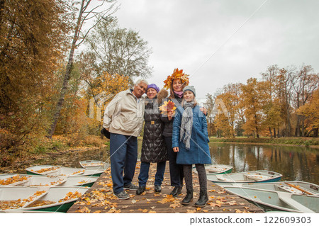 Portrait of happy family generation together in autumn park Portrait of happy family generation together in autumn park 122609303