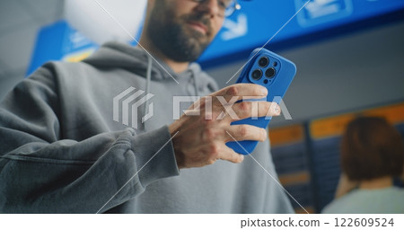 Close Up of Man Scanning Plane Ticket Using Smartphone to Check Flight Information Close Up of Man Scanning Plane Ticket Using Smartphone to Check Flight Information 122609524