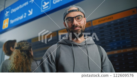 Airport Terminal: Man Scanning Plane Ticket Using Smartphone, Smiling, Looking at Camera 122609576